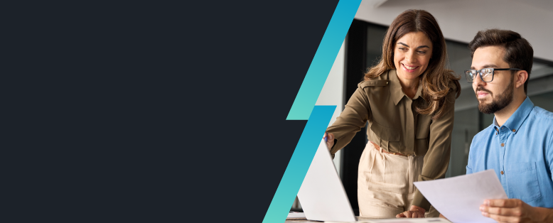 Smiling businesswoman and businessman in glasses holding paper collaborate on a laptop using Sage Intacct for recruitment